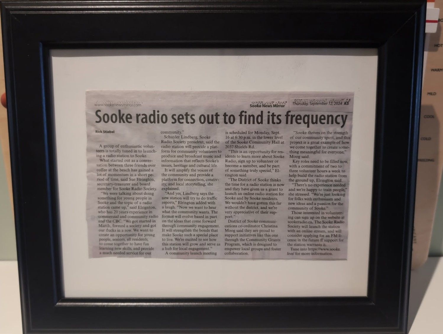 A newspaper clipping in a frame, titled "Sooke radio sets out to find its frequency"